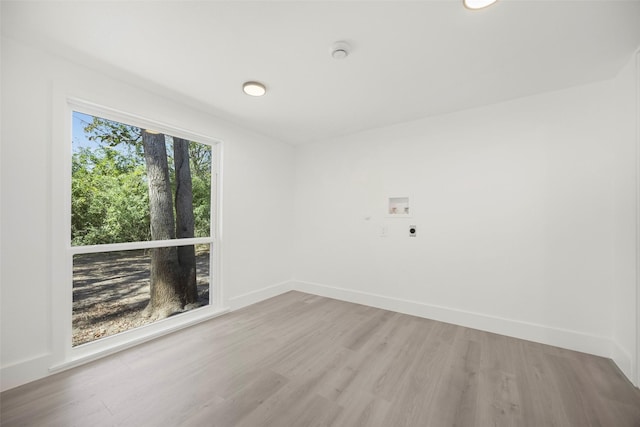 empty room with baseboards and wood finished floors