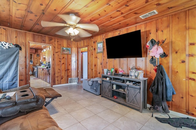 living area featuring light tile patterned floors, wooden ceiling, visible vents, and a ceiling fan