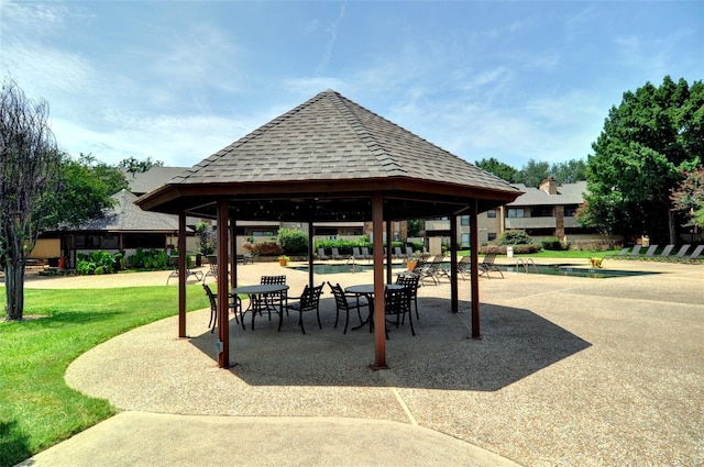 view of home's community featuring a pool, a patio area, a lawn, and a gazebo