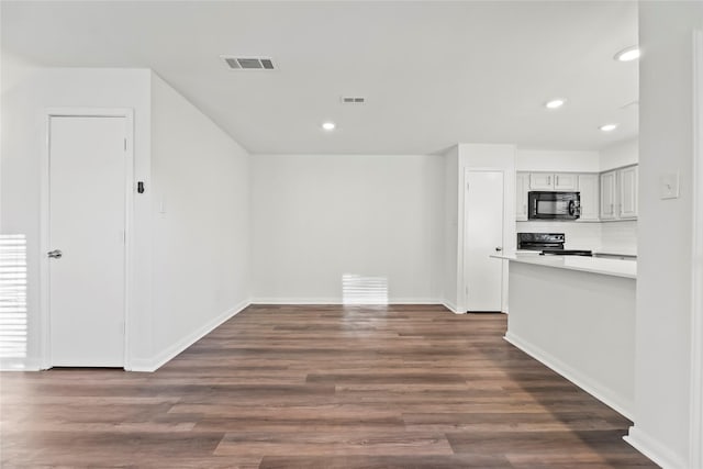 interior space featuring dark wood-style floors, visible vents, and recessed lighting