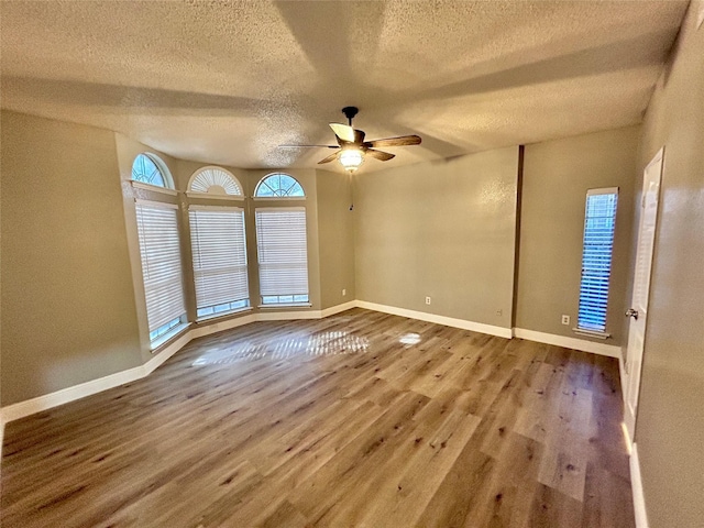 unfurnished room with wood finished floors and baseboards