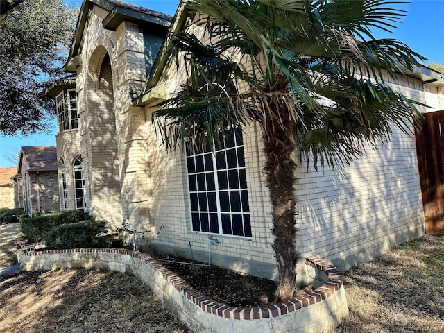 view of property exterior with brick siding