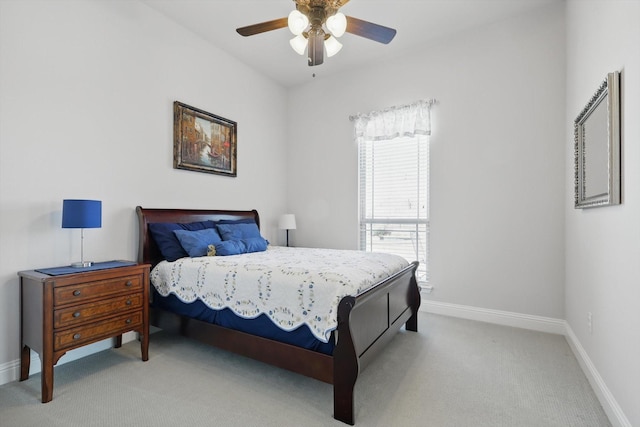 bedroom featuring light carpet, baseboards, and a ceiling fan