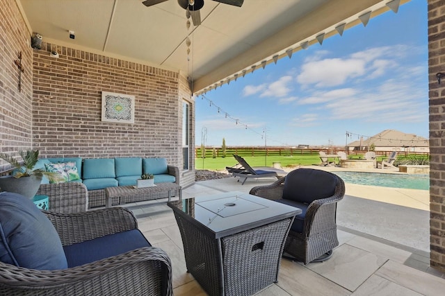 view of patio featuring ceiling fan, fence, and an outdoor hangout area