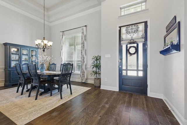 entryway with a chandelier, dark wood-style flooring, a high ceiling, and baseboards