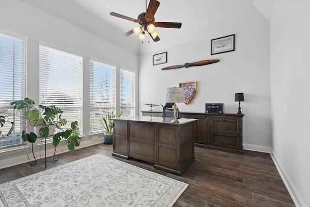 office area with dark wood-style floors, ceiling fan, and baseboards