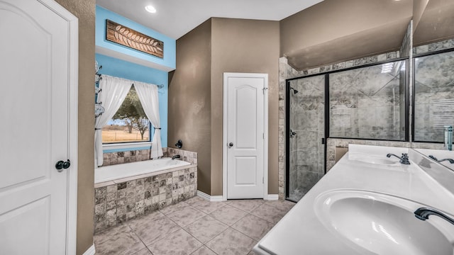 full bathroom with a stall shower, tile patterned flooring, a garden tub, and a sink