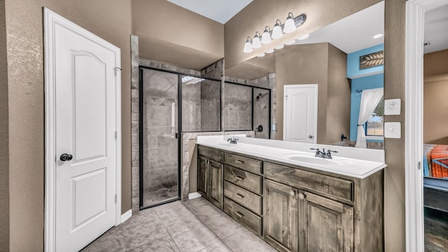 bathroom featuring double vanity, tile patterned flooring, a sink, and a shower stall