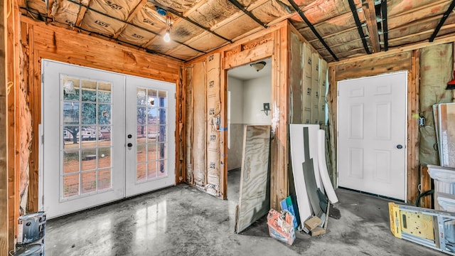 doorway to outside featuring french doors and concrete floors