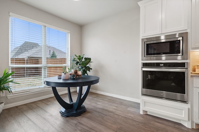 dining area featuring wood finished floors and baseboards