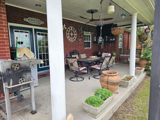 view of patio / terrace featuring a porch, outdoor dining space, and a ceiling fan