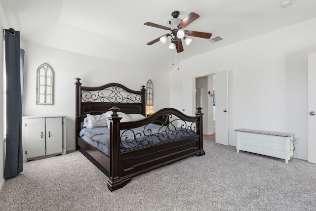 bedroom featuring ceiling fan, vaulted ceiling, carpet, and visible vents