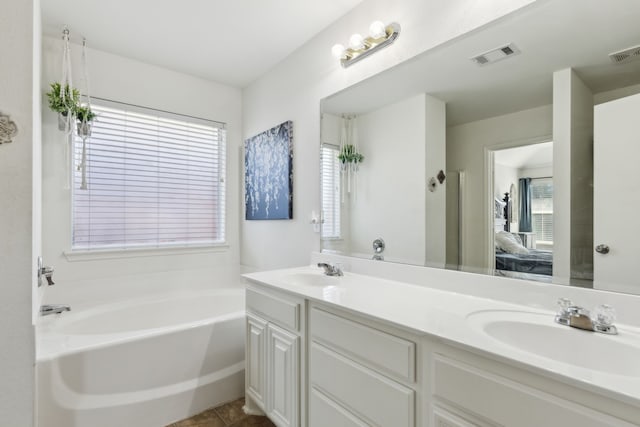 ensuite bathroom featuring visible vents, a sink, and ensuite bathroom