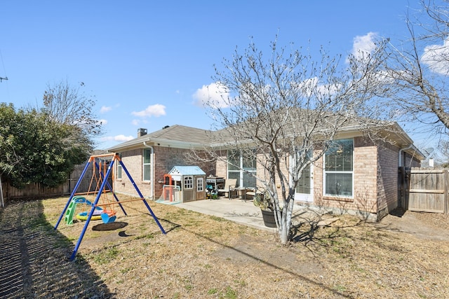 10509 Splitridge Ct, Fort Worth, TX 76108 - back of property with a playground, a patio, brick siding, and a fenced backyard