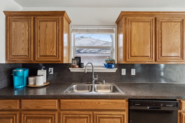 kitchen featuring black dishwasher, brown cabinetry, dark countertops, and a sink