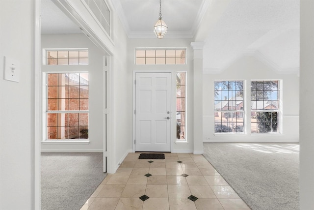 tiled foyer entrance featuring a towering ceiling, baseboards, ornamental molding, and carpet flooring