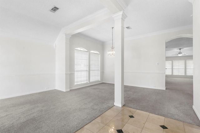 tiled spare room with arched walkways, a wealth of natural light, carpet flooring, and visible vents