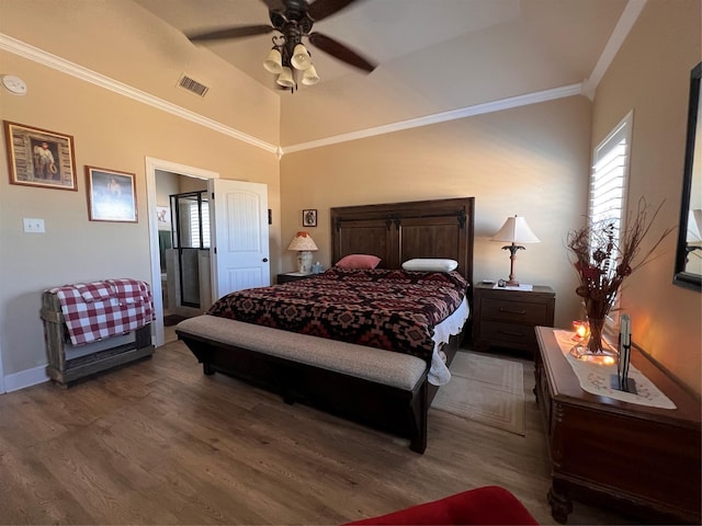 bedroom featuring a ceiling fan, wood finished floors, visible vents, and crown molding