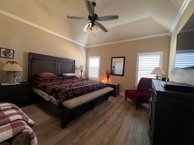 bedroom featuring lofted ceiling, multiple windows, and wood finished floors