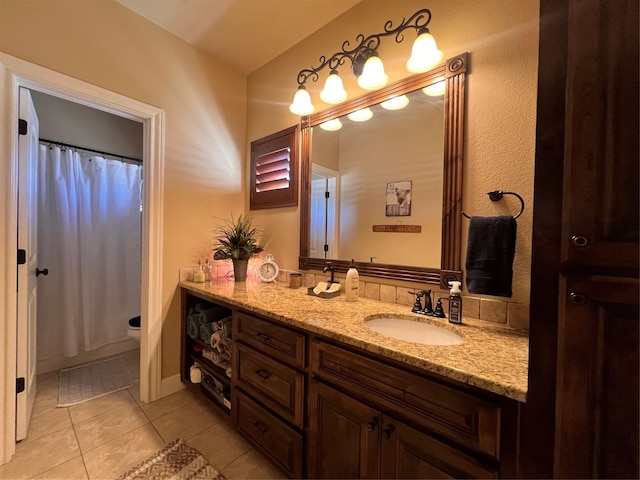 bathroom featuring toilet, tile patterned floors, and vanity