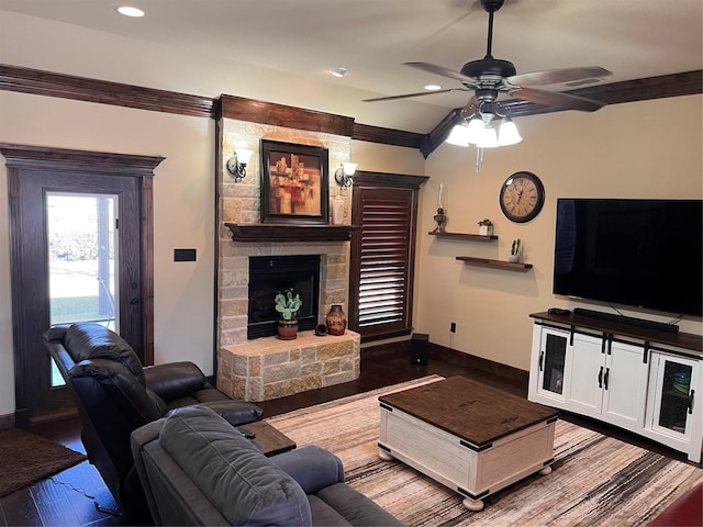 living area featuring baseboards, ceiling fan, wood finished floors, a stone fireplace, and recessed lighting