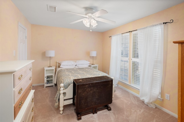 bedroom with light carpet, baseboards, visible vents, and ceiling fan