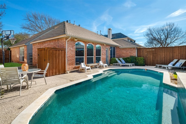 view of swimming pool featuring a fenced in pool, fence private yard, and a patio