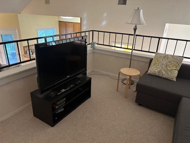 living area with carpet flooring, visible vents, and baseboards