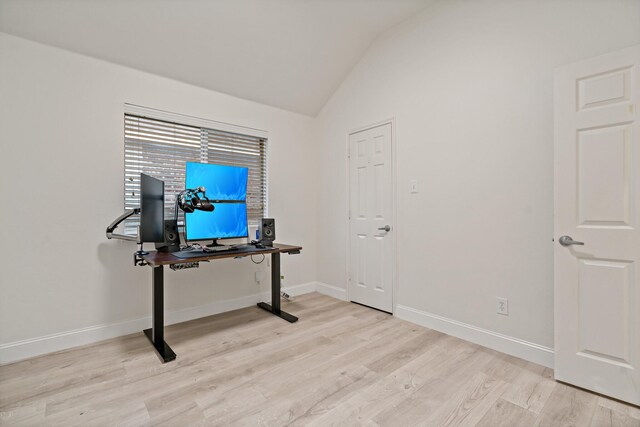 office area with light wood-type flooring, lofted ceiling, and baseboards