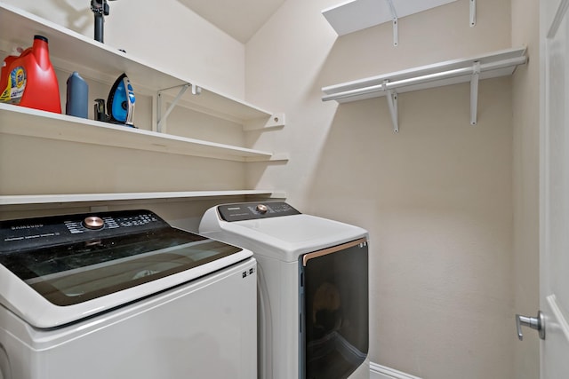 clothes washing area featuring laundry area and washing machine and clothes dryer