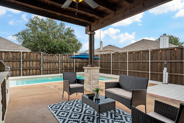 view of patio / terrace with outdoor lounge area, a fenced backyard, a fenced in pool, and a ceiling fan