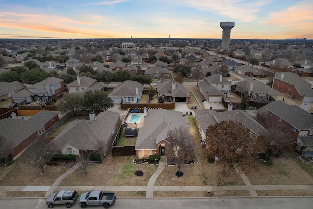 aerial view at dusk featuring a residential view