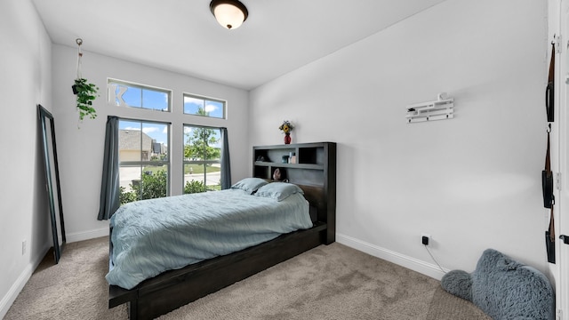 bedroom with carpet and baseboards