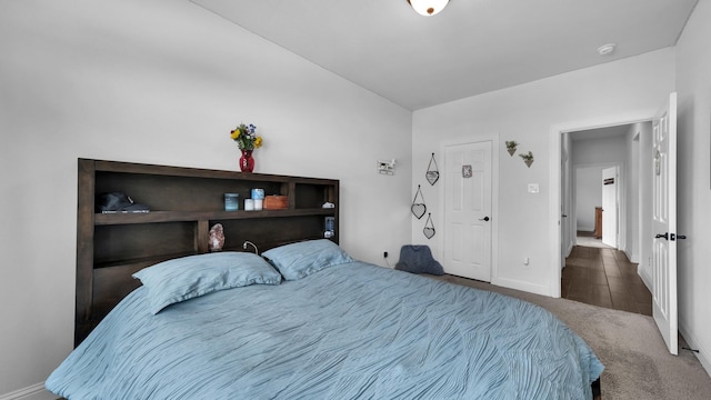 bedroom with baseboards and carpet flooring