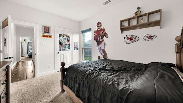 carpeted bedroom with visible vents and baseboards