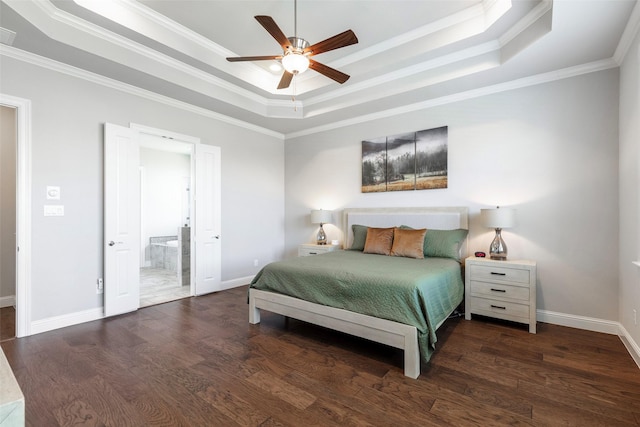 bedroom with ornamental molding, a tray ceiling, and wood finished floors