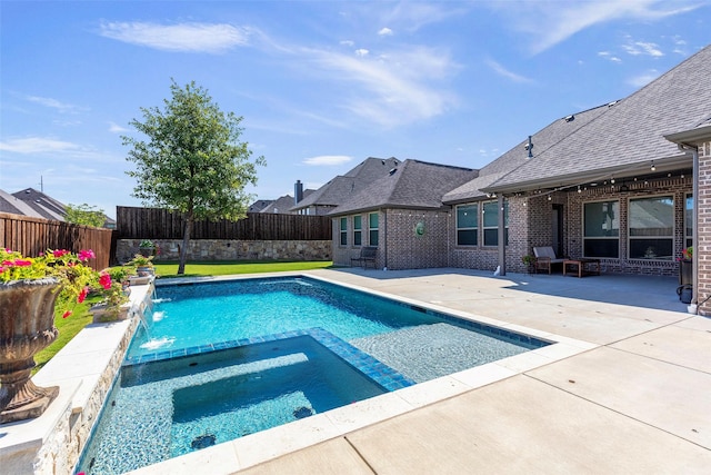 view of swimming pool with a patio area, a fenced backyard, and a pool with connected hot tub