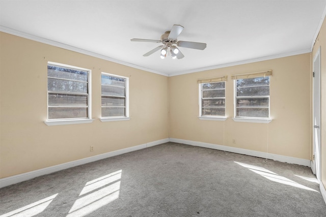 spare room featuring carpet, baseboards, ornamental molding, and ceiling fan