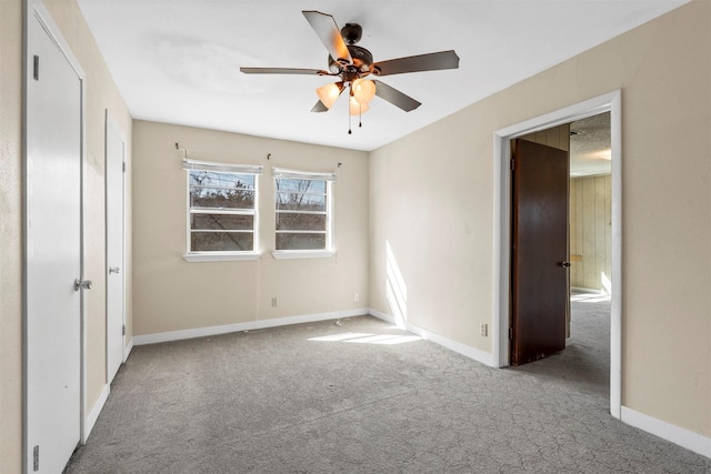 unfurnished bedroom with carpet floors, ceiling fan, and baseboards