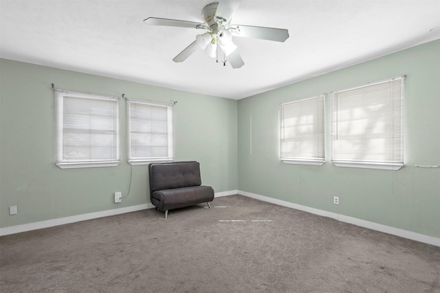 unfurnished room featuring carpet floors, plenty of natural light, baseboards, and a ceiling fan