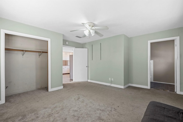 unfurnished bedroom featuring a ceiling fan, a closet, carpet flooring, and visible vents