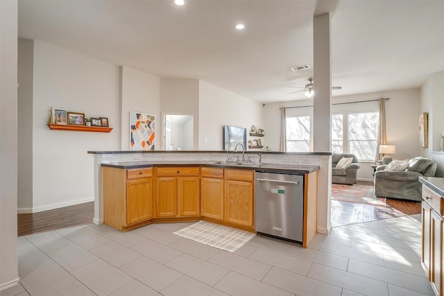 kitchen featuring visible vents, ceiling fan, open floor plan, dishwasher, and a sink