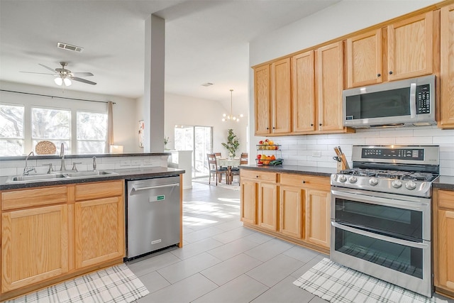 kitchen featuring a sink, appliances with stainless steel finishes, and light brown cabinets