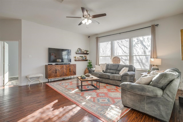 living room with visible vents, wood finished floors, baseboards, and ceiling fan