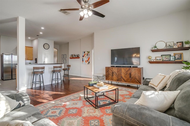 living room with visible vents, baseboards, ceiling fan, recessed lighting, and wood finished floors