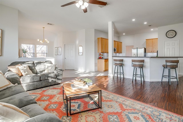 living room featuring recessed lighting, visible vents, ceiling fan with notable chandelier, and light wood finished floors