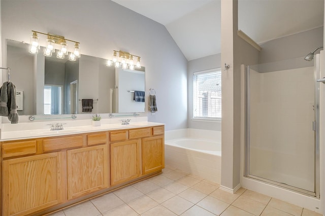 bathroom with a shower stall, a garden tub, vaulted ceiling, tile patterned floors, and a sink