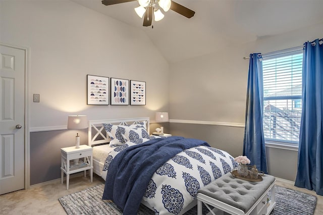 carpeted bedroom with ceiling fan and vaulted ceiling