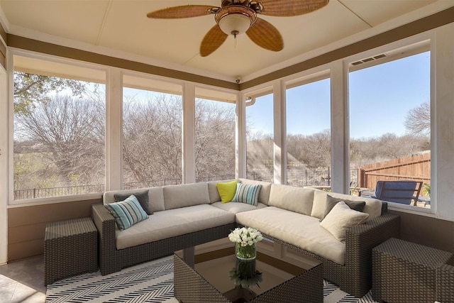 sunroom / solarium with visible vents and a ceiling fan