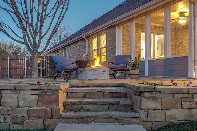 exterior space with an outdoor fire pit and fence